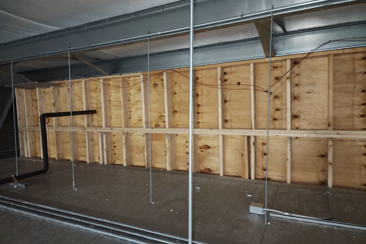 Conduit runs in an empty agricultural building before equipment is installed