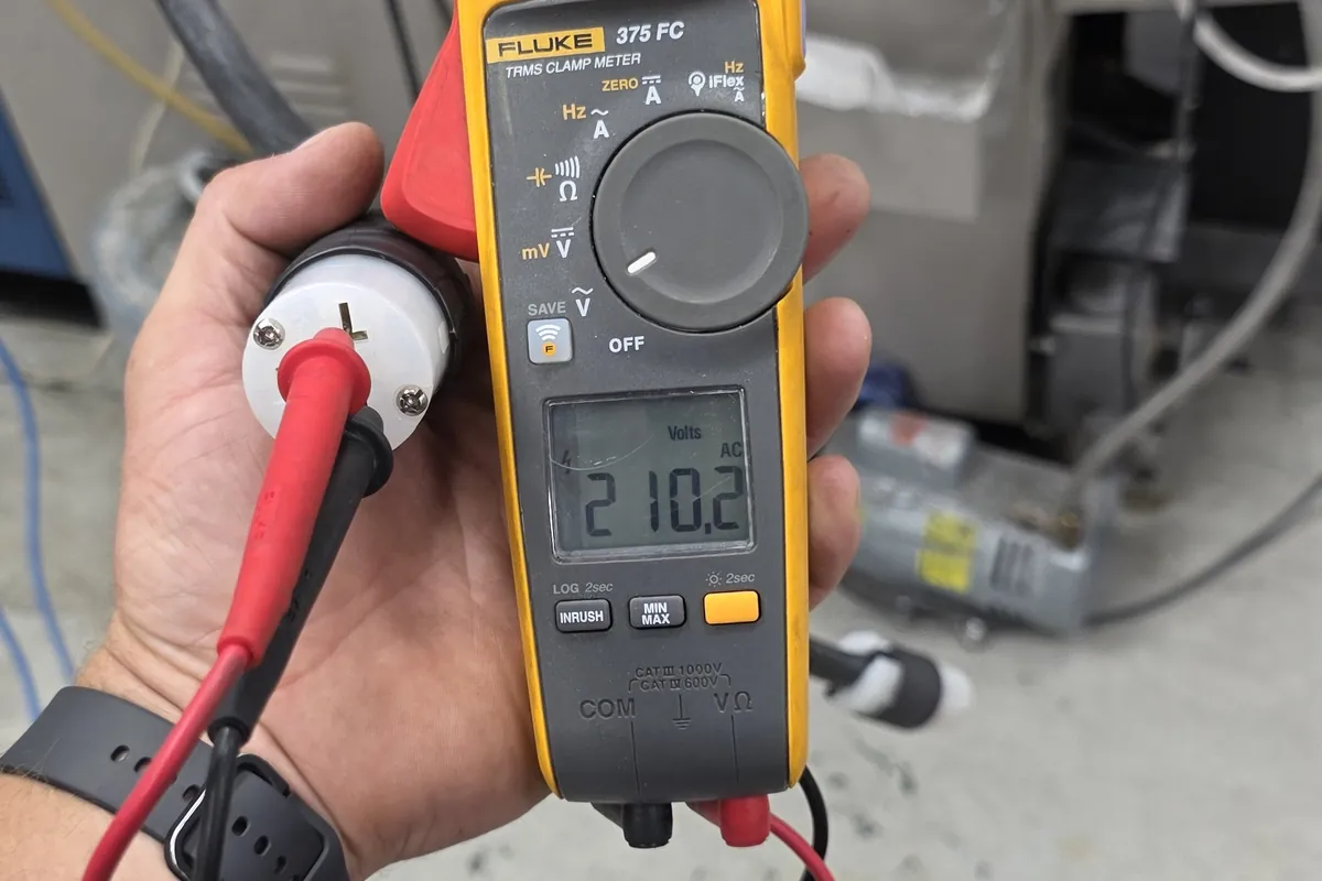 Clamp meter being used to take a reading during testing