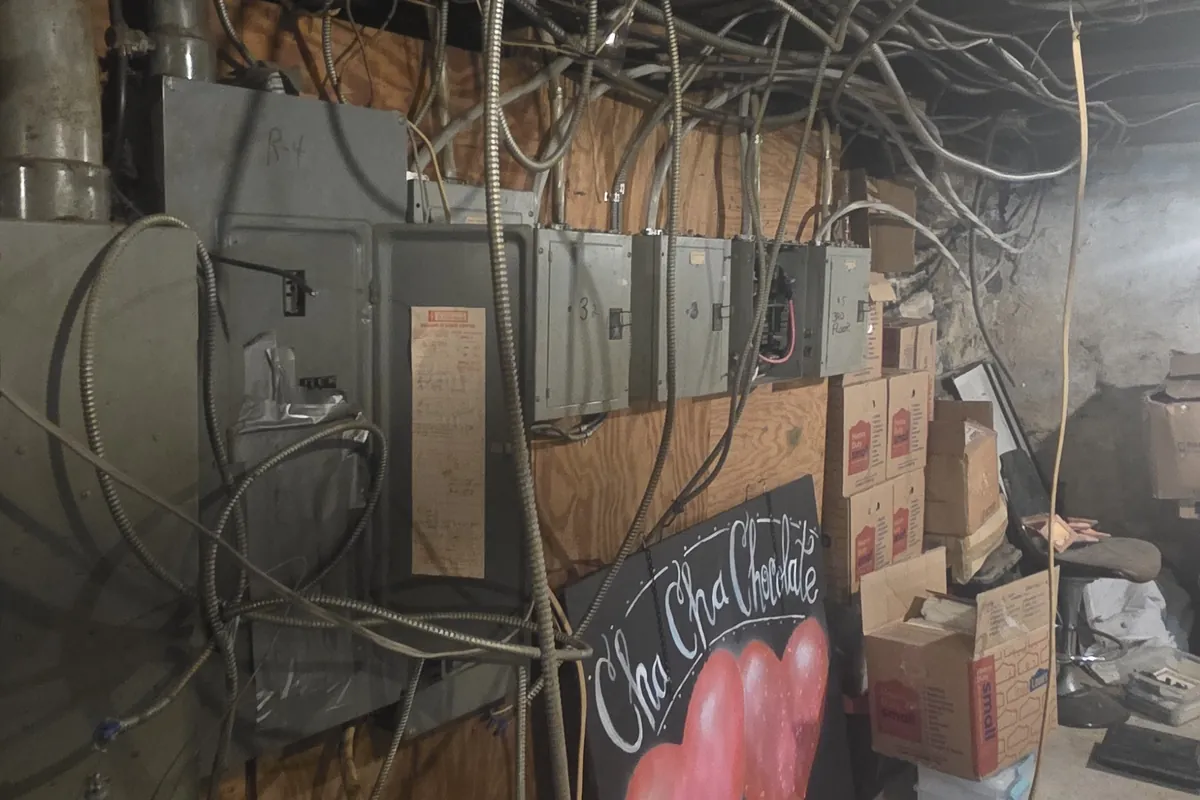 Row of older electrical panels along a barn wall