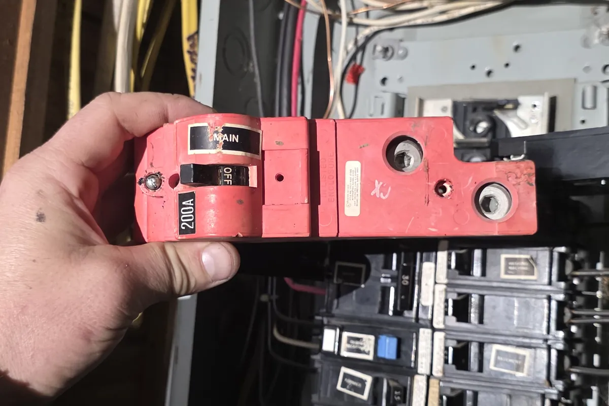 Technician taking a meter reading at an electrical panel