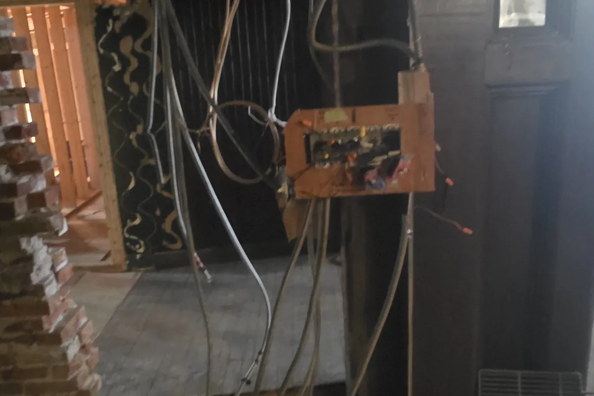 Dim older farm building interior with aged wiring
