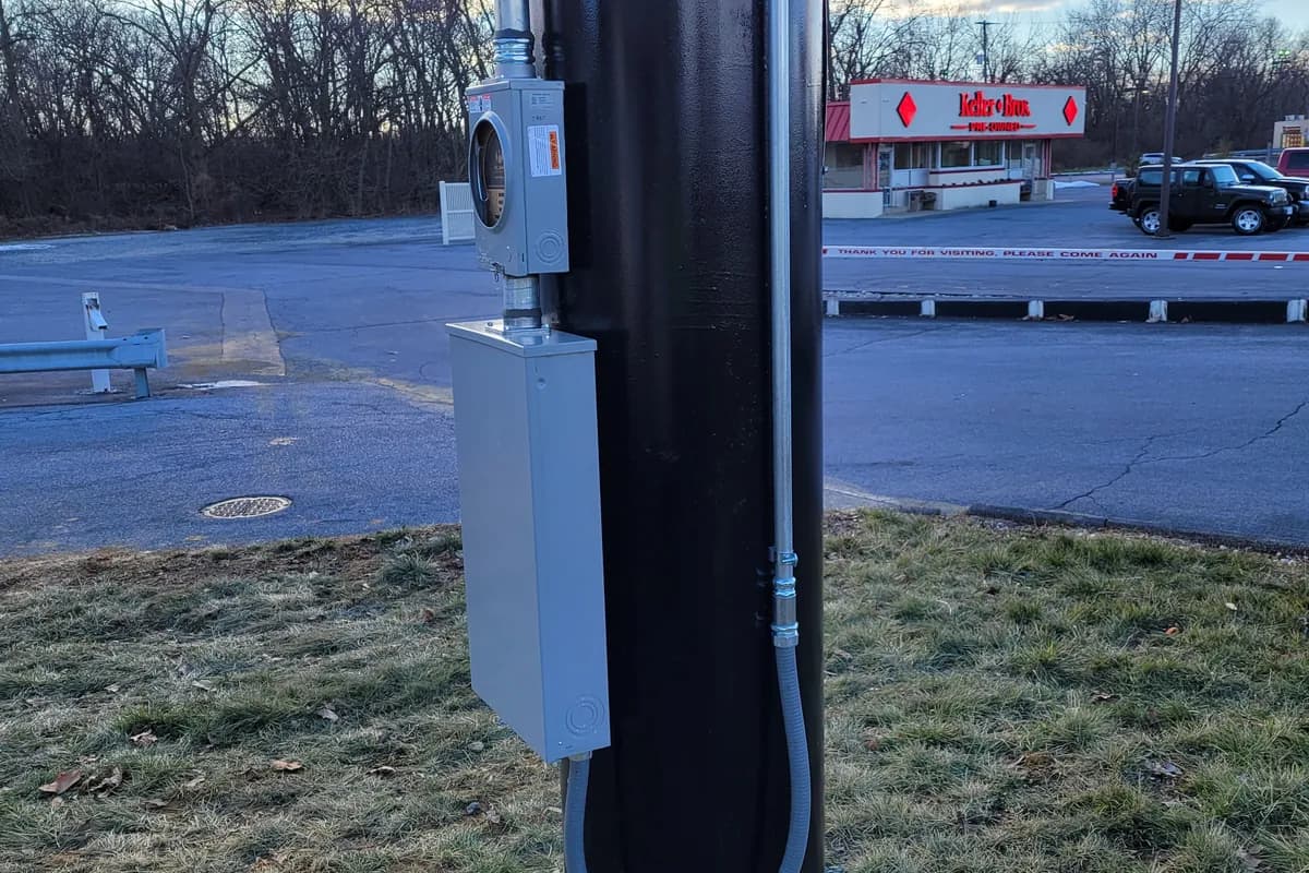 Concrete lighting pole base on a parking lot